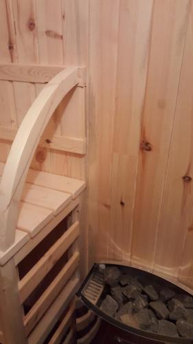 a bathroom with a wooden shower with a shelf at Holiday Home Floris in Kopaonik