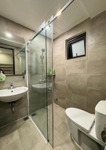 a bathroom with a shower and a toilet and a sink at Studio 3 ByhomeLinh Phố Cổ Hoàn Kiếm in Hanoi