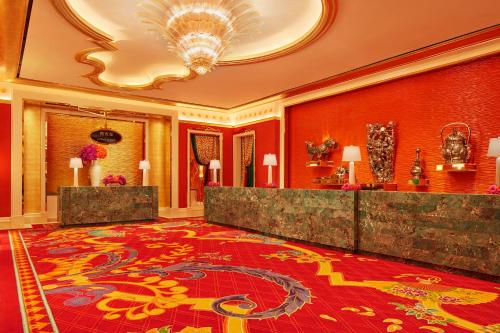 a hotel room with a lobby with a red carpet at Wynn Palace in Macau