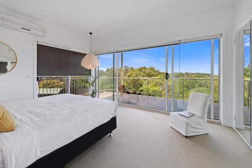 a bedroom with a white bed and a balcony at Barbro Warrnambool in Warrnambool