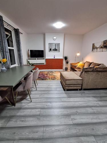 a living room with a couch and a table at home from home 2 bed flat in Kingston upon Thames