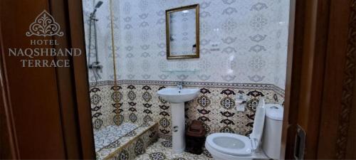 a bathroom with a sink and a toilet and a mirror at Hotel Naqsh-band Terrace in Bukhara