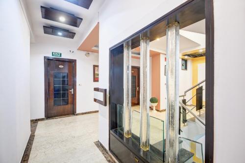 a hallway with a glass door and a staircase at Hotel Star Plaza - 1 Minute From New Delhi Railway Station & Connaught Place in New Delhi