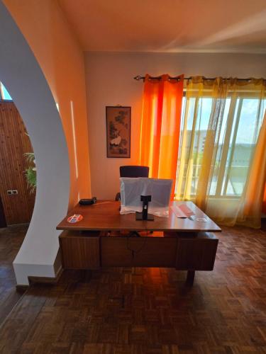 an office with a desk with a laptop on it at Casa TIANA in Mindelo