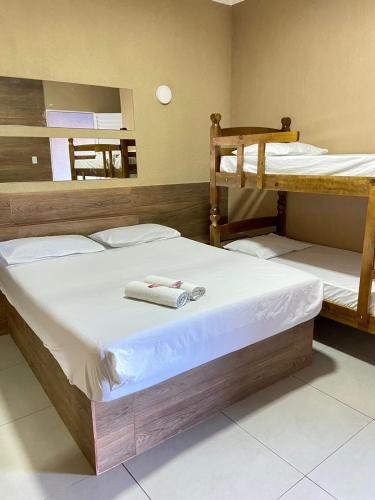a bedroom with two bunk beds with towels on them at Parati - Hotel Pousada e Motel in Quatá