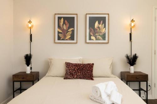 a bedroom with a white bed with two night stands at Near UNT - Downtown Denton - Full Fenced Backyard in Denton