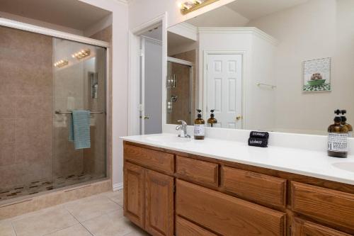 a bathroom with a sink and a shower at Near UNT - Downtown Denton - Full Fenced Backyard in Denton
