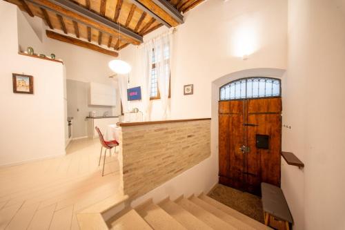 a hallway with a wooden door and a table at Apartment in the historic center of Perugia in Perugia