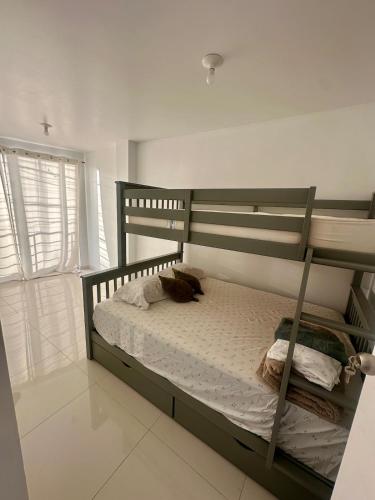 a bedroom with a bunk bed and a window at House in front of Pisco-Paracas beach in Pisco