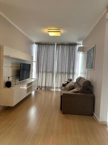 ein Wohnzimmer mit Sofa und Fernseher in der Unterkunft Ap Independecia in Santa Cruz do Sul