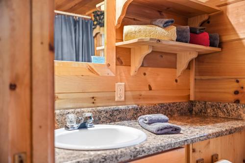 a bathroom with a sink in a tiny house at Sleepy Creek - Hot Tub, Pet Friendly, Creekside, Grill, Wifi, Fire Pit, Deck, Screen Porch, Family Friendly, Fishing, View, Games in Berkeley Springs