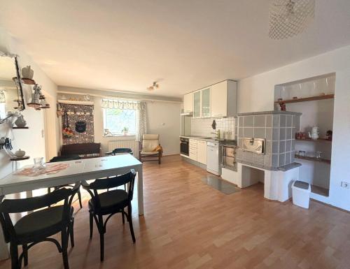 une cuisine avec une table et des chaises dans une pièce dans l'établissement Granny's Cosy Cottage, 