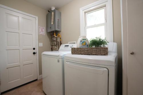 a laundry room with a washer and dryer and a window at Destination #06 in Anaheim