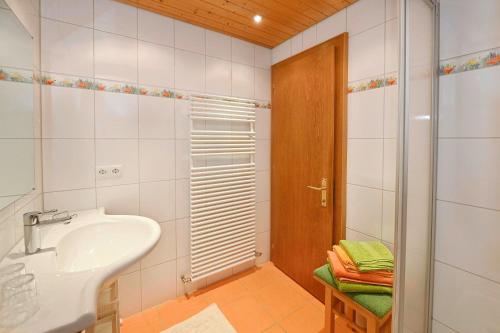 a white bathroom with a sink and a shower at Rundblick 2 Gartenwohnung in Tschagguns