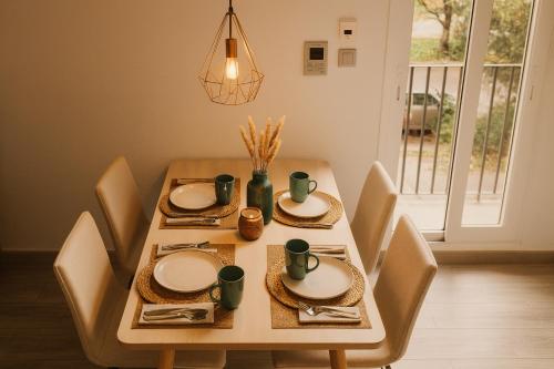 a dining room table with chairs and plates at MODERNO NUEVO Luminoso WI-FI PLAZA DEL PILAR 2 in Zaragoza