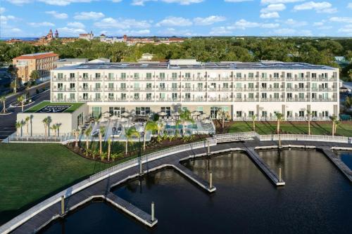 a large white building with a bridge over a body of water at AC Hotel St Augustine Downtown in St. Augustine
