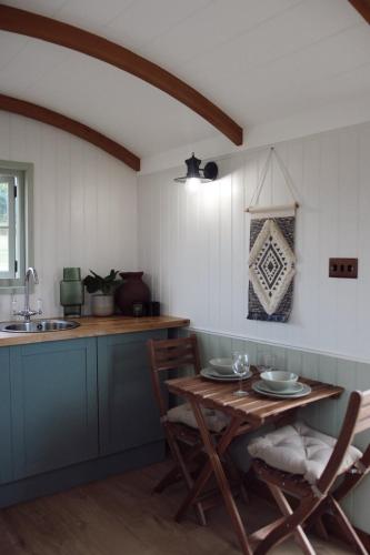 a kitchen with a table and chairs and a sink at Meadow View Country Park in Horton
