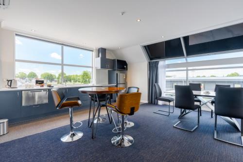 a kitchen and dining room with a table and chairs at Hamilton Suites in Hamilton