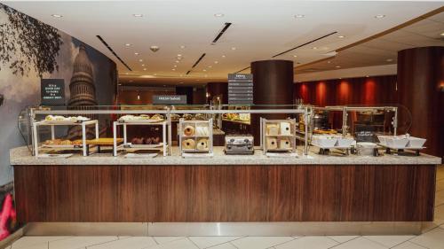 a restaurant with a counter with food on it at Holiday Inn Washington Capitol-National Mall by IHG in Washington
