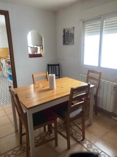a wooden table and chairs in a room at El Doblao del Rey in Torrejón del Rey