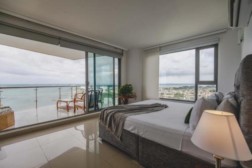 ein Schlafzimmer mit Bett und Blick auf das Meer in der Unterkunft SkyMar Luxury 27 in Cartagena de Indias