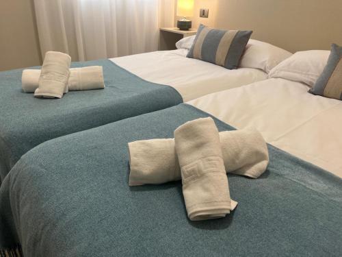 two beds in a hotel room with pillows on them at Hola La Fuente in Puerto de Mogán
