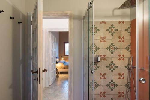a bathroom with a glass shower with a bedroom at Villa Corallo Cala Bianca in Castellammare del Golfo