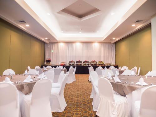 a banquet hall with white tables and white chairs at Holiday Inn Tijuana Zona Rio by IHG in Tijuana