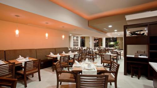 a dining room with wooden tables and chairs at Holiday Inn Tijuana Zona Rio by IHG in Tijuana