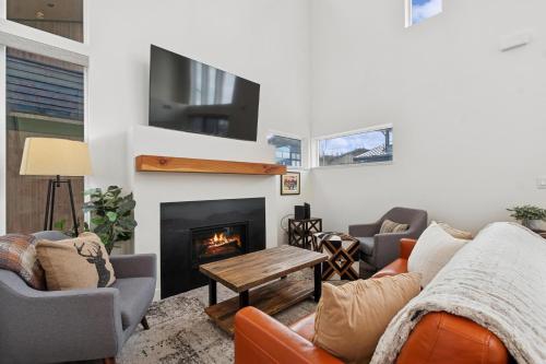 a living room with couches and a fireplace at Quarry B5 in Whitefish