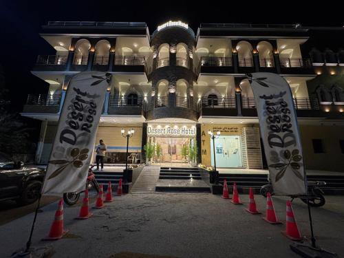 a building with orange cones and flags in front of it at desert rose hotel-فندق ديزرت روز in Siwa