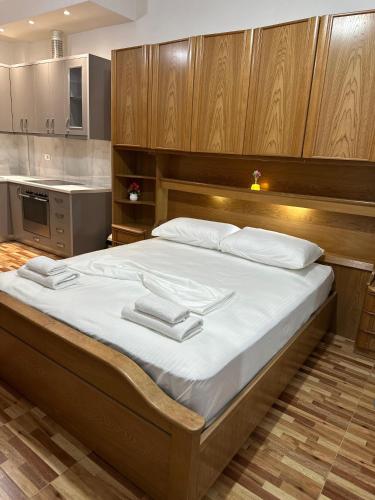 a bedroom with a large bed with towels on it at Eyar house in Kamëz