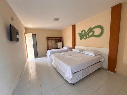 Ένα ή περισσότερα κρεβάτια σε δωμάτιο στο Pousada Tabatinga