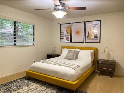 a bedroom with a bed and a ceiling fan at Cozy Cabin Near Yosemite & Bass lake, Breathtaking Views & Private Hot Tub, BBQ, Nature Getaway in Oakhurst
