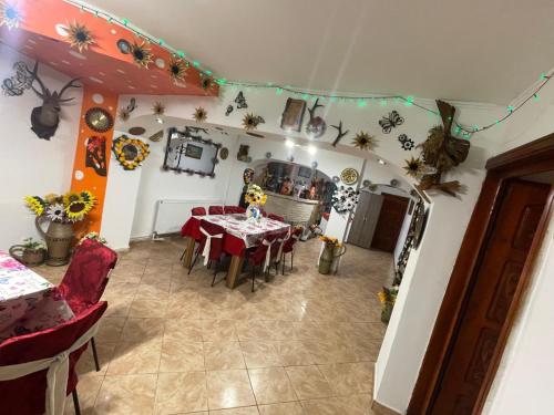 a dining room with a table and red chairs at Vila Movilă in Azuga