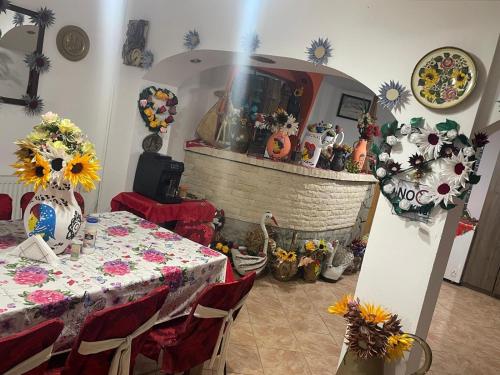 a room with a table and a fireplace with vases at Vila Movilă in Azuga