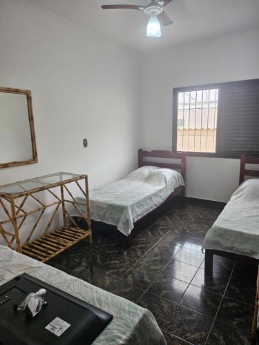 En eller flere senge i et værelse på Joia de Peruíbe