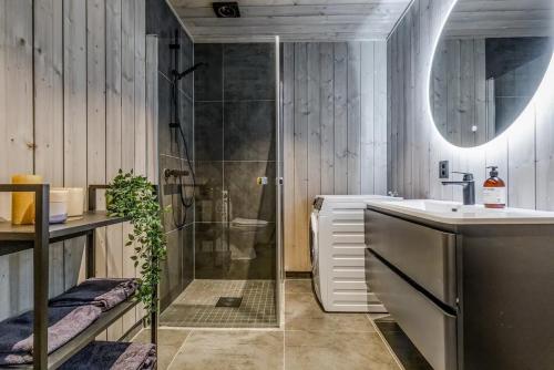 a bathroom with a shower and a sink and a toilet at Fjellperlen, Hardangervidda in Eidfjord