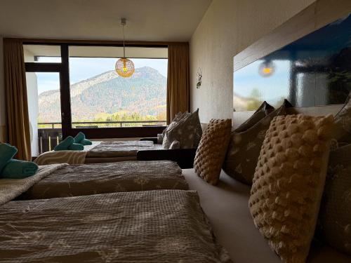 a bedroom with three beds and a large window at Appartement Oriold in Bad Goisern