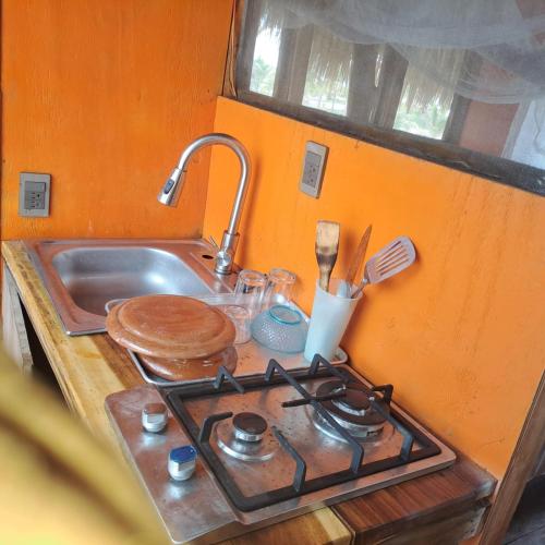 a kitchen counter with a stove and a sink at Chak in Tonalá