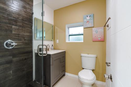 a bathroom with a toilet and a glass shower at Beautiful, fully furnished 2bed 1bath house - 5 minute walk to Miracle Mile Downtown Coral Gables in Miami