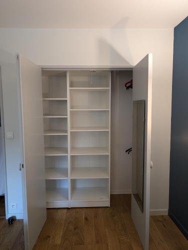a room with white shelves and a closet at Chez Nicolas Marseille 13009 in Marseille
