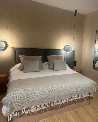 a bedroom with a large bed with white sheets and pillows at Xaneira in Finisterre