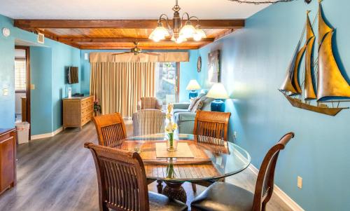 a dining room with a table and chairs at Royal Holiday Beach Resort in Biloxi