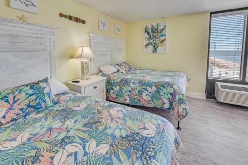 a hotel room with two beds and a window at Pets welcome,direct oceanfront, poolside,1 bedroom in Myrtle Beach
