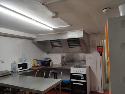 a kitchen with a table and a stove top oven at Number 75 in Brighton & Hove