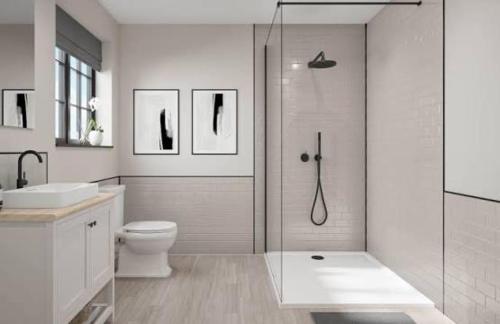 a bathroom with a shower and a toilet and a sink at Stylish 2BD, Near O2, WIF, Sleeps 6, London in London
