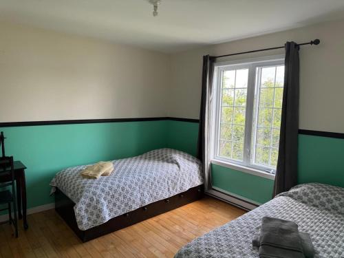 Ένα ή περισσότερα κρεβάτια σε δωμάτιο στο Havre du lac magog