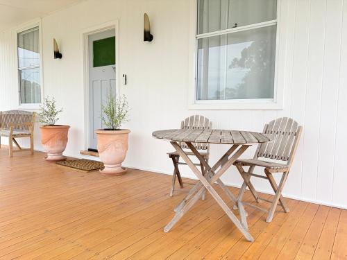 a wooden table and two chairs in a room at The Kandos Nook- Adventure, Wine & Country Charm in Kandos