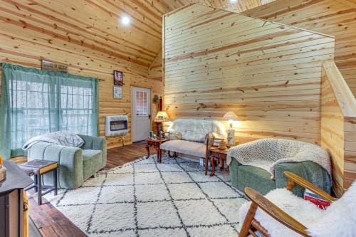 a log cabin living room with two couches and a tv at Greenbrier River On-Site! Modern-Rustic Log Cabin in Marlinton